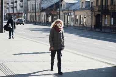 Coronavirus hastalığının yayılması için maske takan Coronavirus Genç kız. Yüzünde cerrahi maske olan genç bayana yakın durun.