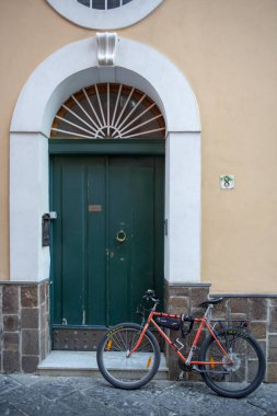 Walking through the alleys of Procida, bicycle clipart