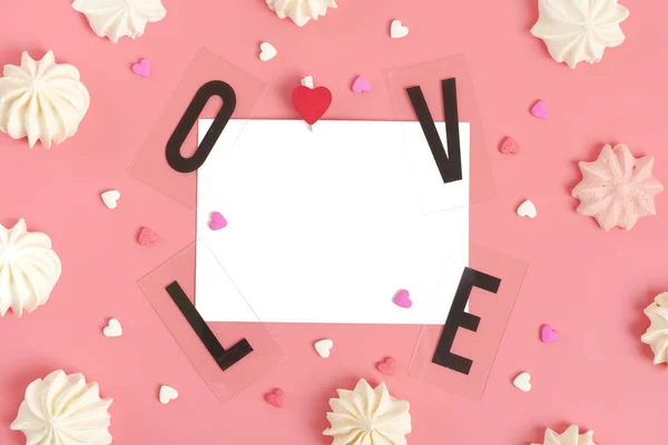白纸上写着给心爱的人的信息 爱这个词的黑色字母 糖果的心形在粉色的背景上 情人节快乐的概念 — 图库照片
