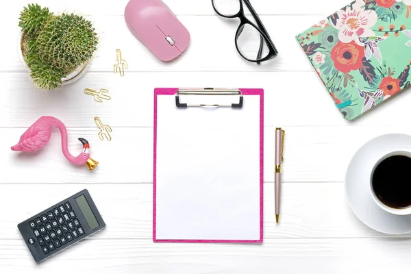 Fashion feminine home office workplace. Tablet, calculator, notepad, golden pen, clips, glasses, cup of coffee, succulent on white wooden background Top view Flat lay Freelance work, business concept