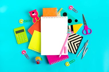 Stationary, back to school, summer time, creativity and education concept School supplies - dividers, pencils, paper clips, note, stapler, notepad, globe on blue background, flat lay Mock up Top view. clipart