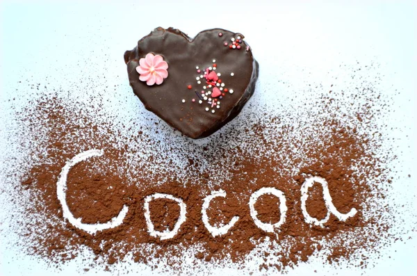 Cake in the shape of a heart with chocolate and cocoa powder — Stock Photo, Image