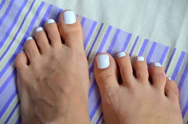 Female beautiful feet - white pedicure — Stock Photo, Image