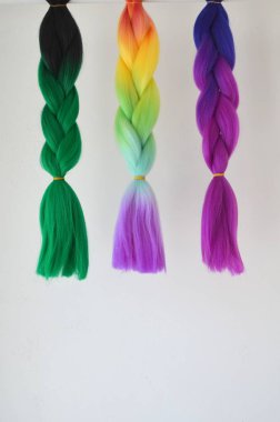 Kanekalon. Colored artificial strands of hair. Material for plaiting braids clipart