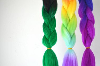 Kanekalon. Colored artificial strands of hair. Material for plaiting braids clipart