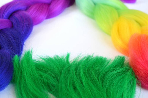 Kanekalon. Colored artificial strands of hair. Material for plaiting braids.