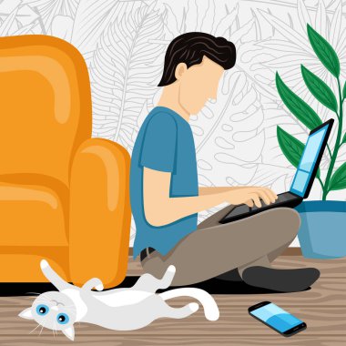 Yerde dizüstü bilgisayarı ve sevimli kedisi olan bir adam oturuyor..