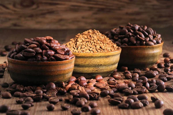 Coffee beans pile and coffe instant on the background of ground coffee