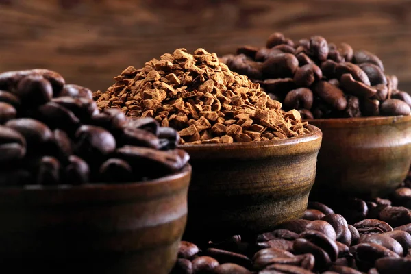 Coffee beans pile and coffe instant on the background of ground coffee