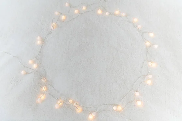 Christmas garland lights from LED bulbs on the carpet background — Stock Photo, Image