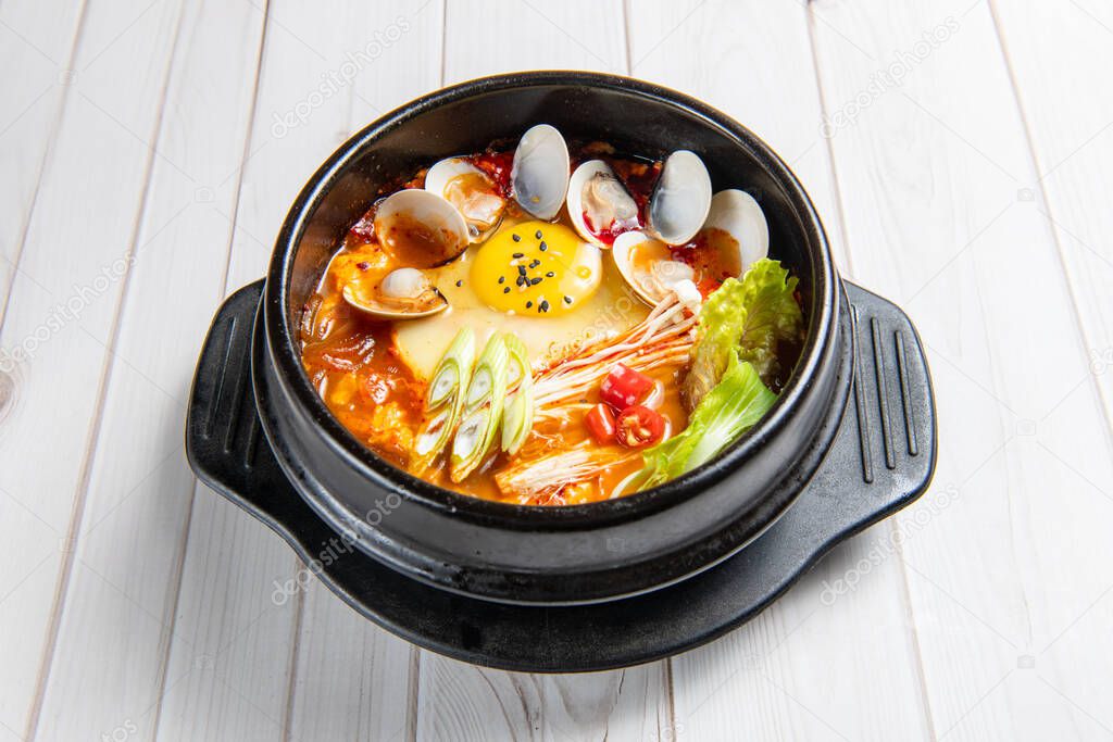 Kimchi jjigae or kimchi stew is a Korean dish, made with kimchi and other ingredients, such as scallions, onions, diced tofu, pork, tuna and seafood.