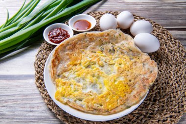 scallion pancake, is a Chinese, savory, unleavened flatbread folded with oil and minced scallions. clipart