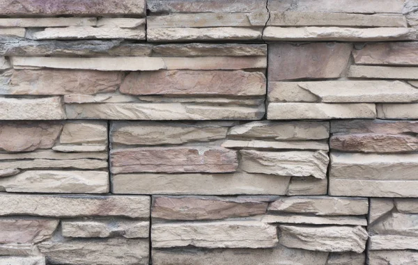 Beautiful wall made of tiles imitating natural stone. Finishing material - tile \