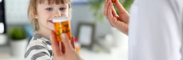 Cute kid choosing vitamins — Stock Photo, Image