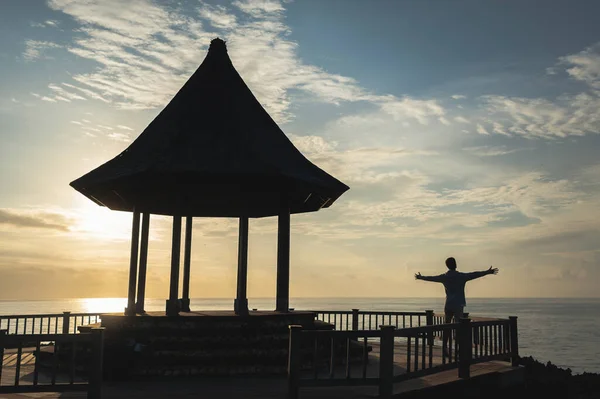 Man greets the world at dawn.