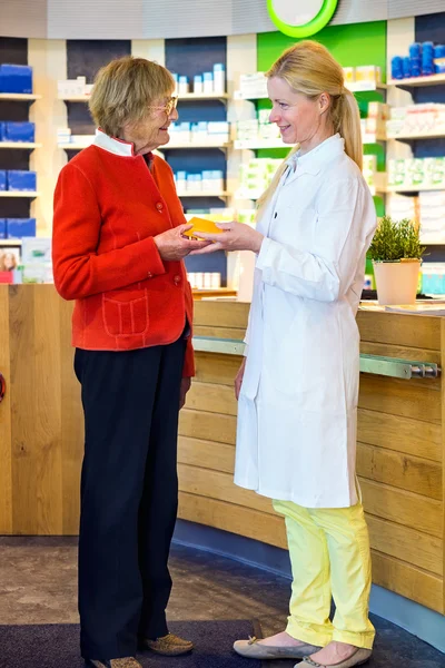 Apotheker gibt verschreibungspflichtige Medikamente — Stockfoto