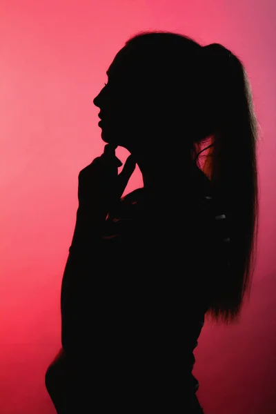Silueta Přemýšlivé Dívky Červeném Osvíceném Pozadí Nerozpoznatelný Profil Obličeje Ženy — Stock fotografie