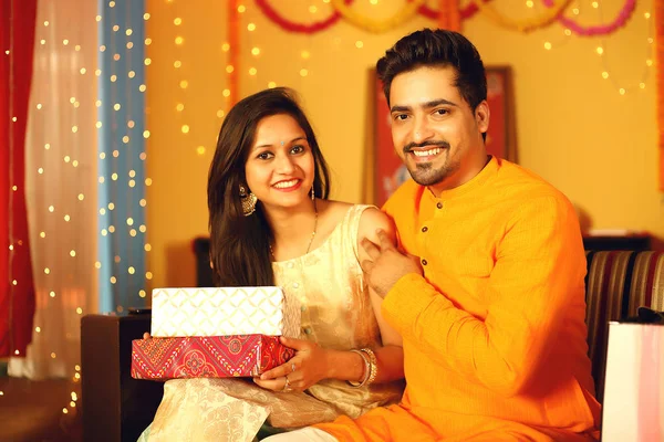 Hintli çift Diwali 'yi kutluyor. Dekoratif arkaplanda izole.