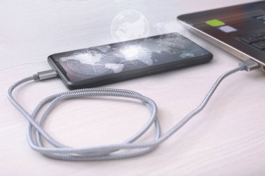 Cep telefonunun fotoğrafı laptopa bağlanıyor. Beyaz bir arkaplanda izole edilmiş.