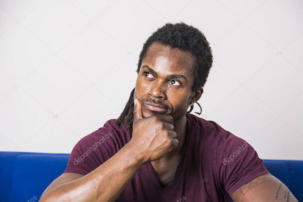 Handsome doubtful black man thinking Stock Photo 