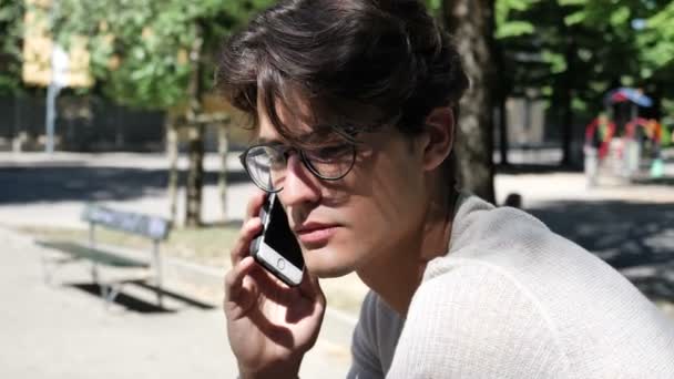 Jeune homme écoutant puis envoyant l'enregistrement vocal sur téléphone portable — Video