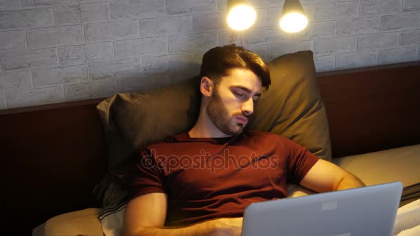 Young man sleeping then waking up at computer — Stock Video