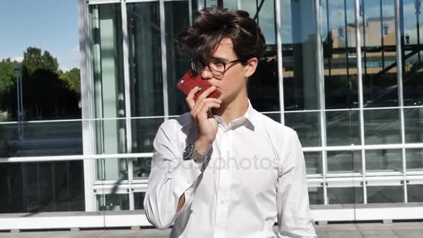 Young man sending voice message with cell phone — Stock Video