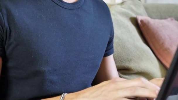 Young Man Doing Homework on Laptop on Couch — Stock Video