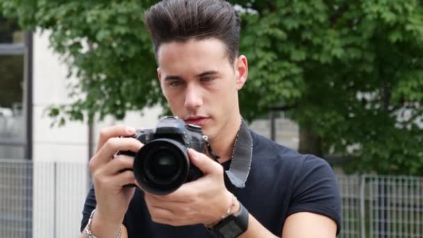 Handsome young male photographer taking photograph — Stock Video