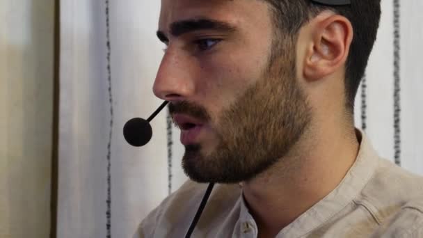 Kulaklık ile genç erkek bir ev işçi — Stok video