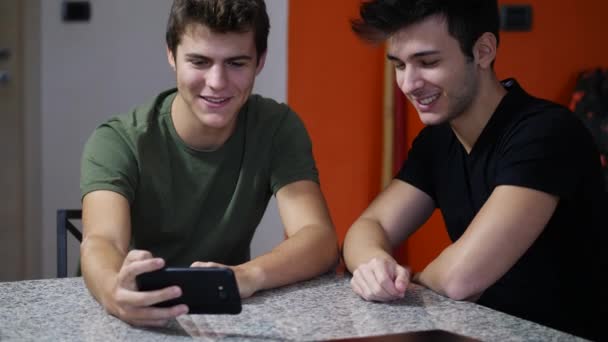 Unga män dela smartphone — Stockvideo