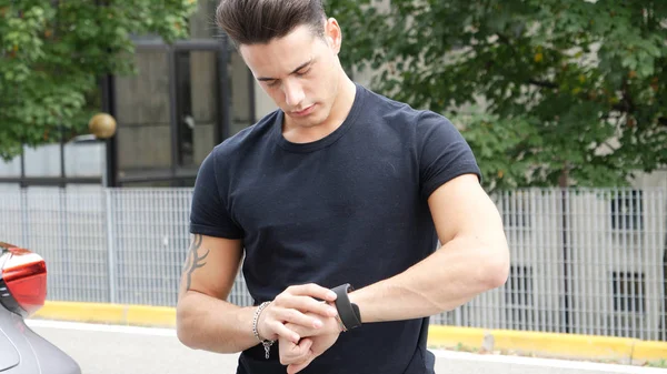 Handsome man checking watch — Stock Photo, Image