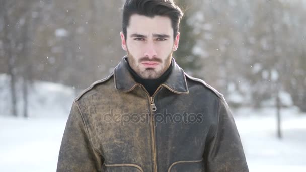 Молодой человек в горах в снегу — стоковое видео
