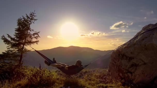 Man Relaxing Hammock Sunset Mountains — ストック動画