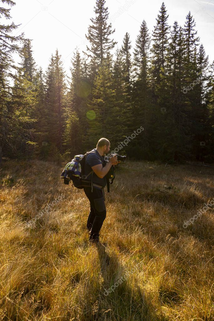 man tourist photographer on a mountai