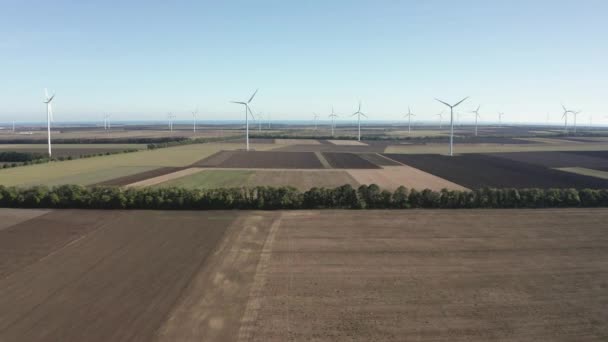Terbang Atas Turbin Angin Modern Melintasi Ladang Pertanian Pembangkit Listrik — Stok Video