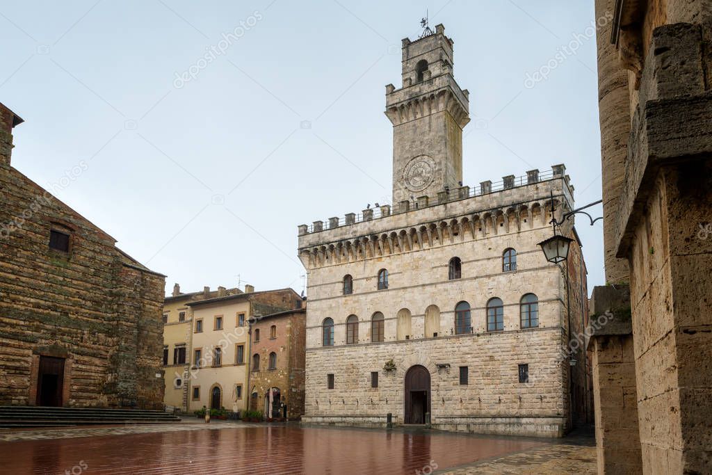 Rainy view of empty medieval Piazza Grande - main square in Montepulciano, Italy with Palazzo Comunale (Town Hall) 