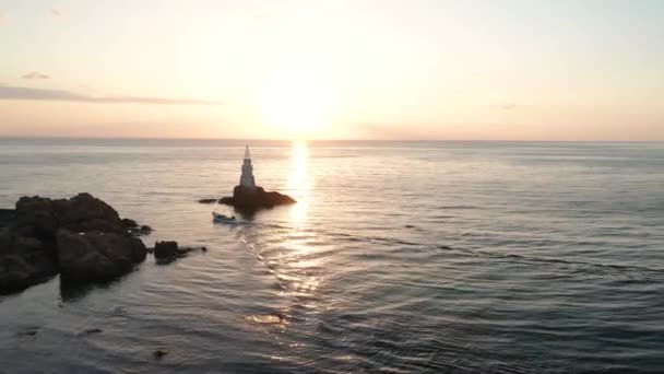 Drohnenflug Bei Sonnenaufgang Einen Leuchtturm Und Ein Kleines Boot Ins — Stockvideo