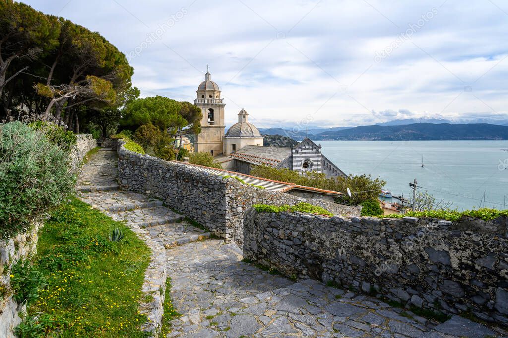 A view from the grounds of Doria Castle towards the Church of San Lorenzo(Chiesa di San Lorenzo) with view on the Bay of Poets in Porto Venere, Italy