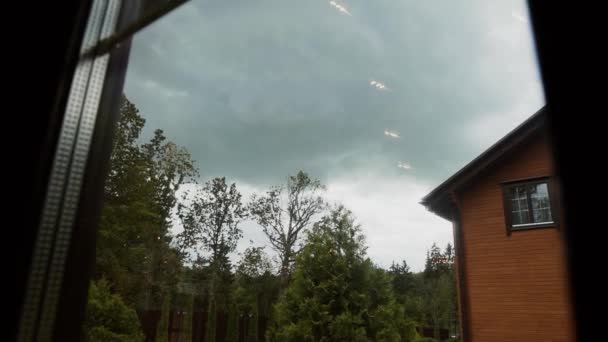 Movement of the view from window on a wooden house in cloudy summer weather — Stock Footage Movement of the view from window on a wooden house in cloudy summer weather Stock Video