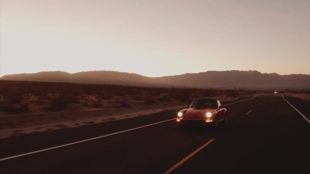 Aerial View Red Classic Car Driving Desolate Desert Road Dusk — Stock Video