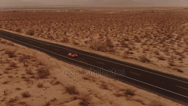 Aerial View Red Classic Car Driving Desolate Desert Road Dusk — Stock Video