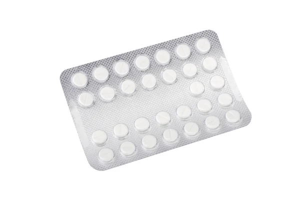 Медицинские таблетки в серебряных блистерных упаковках, изолированных на белой backgrou — стоковое фото