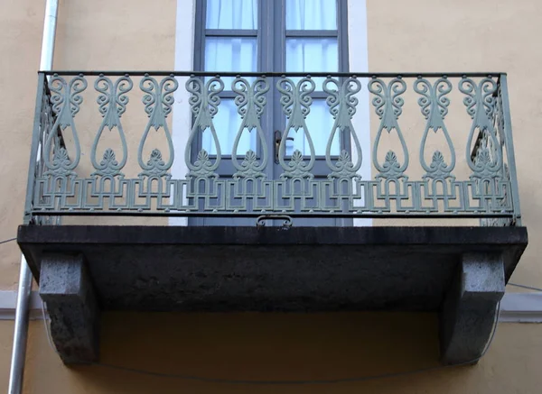 wrought iron railing of a stone terrace, a single block carved from the mountain, typical style of the Italian Alpine houses of the 1900s