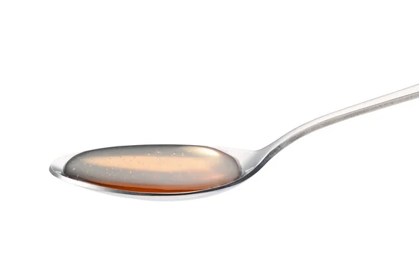 Honey in the stainless steel spoon — Stock Photo, Image