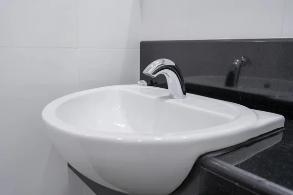 Modern faucet and white ceramic washbasin sink bathroom interior — 스톡 사진