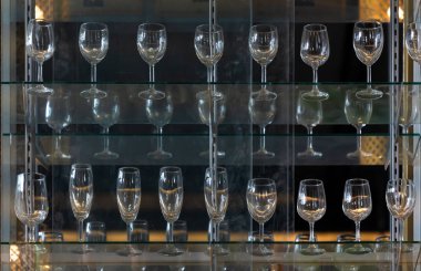 Empty glasses for wine above on glass shelf at bar cafe or resta