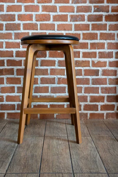 Wooden chair or stool vintage with the old brick wall interior retro style decoration contemporary