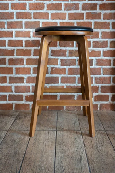 Wooden chairs or stools vintage with the old brick wall interior retro style decoration contemporary