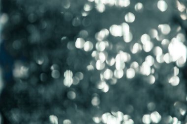 Gizemli gümüş çözünmüş arka plan. Suda gümüş dalgalar ve balık pullarının parıltısı. Parıldayan Bokeh yıldızlı doku.